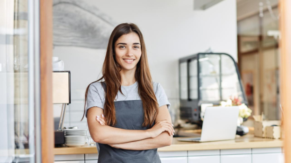 Happy small business owner using a mobile phone
